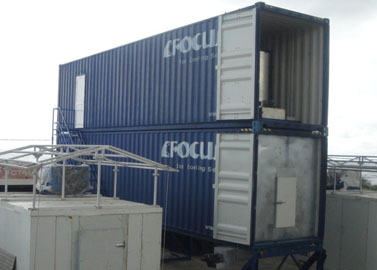 Containerized flake ice machine with auto rake ice storage